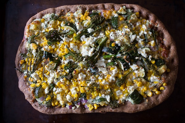 This zucchini corn feta pizza is the perfect way to say goodbye to summer. Packed full of fresh vegetable flavor, cheesy feta and fresh herbs all on a whole wheat crust. 
