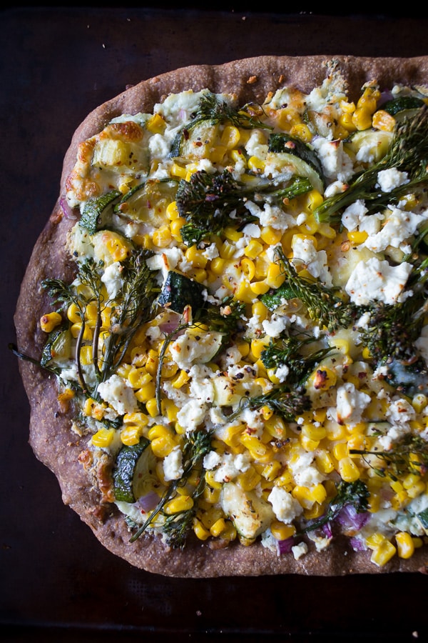 This zucchini corn feta pizza is the perfect way to say goodbye to summer. Packed full of fresh vegetable flavor, cheesy feta and fresh herbs all on a whole wheat crust. 