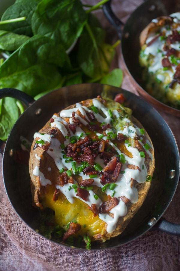 These spinach bacon ranch twice baked potatoes are packed full of flavor and made with a secret ingredients - Greek yogurt ranch dip. So delicious and PACKED full of flavor. They make a great side dish or a main course.