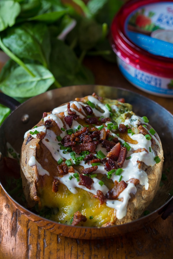These spinach bacon ranch twice baked potatoes are packed full of flavor and made with a secret ingredients - Greek yogurt ranch dip. So delicious and PACKED full of flavor. They make a great side dish or a main course.