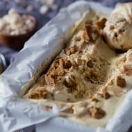 This apple butter gingersnap ice cream in a container scooped to show filling