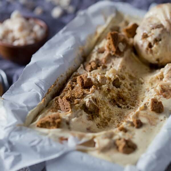 This apple butter gingersnap ice cream in a container scooped to show filling