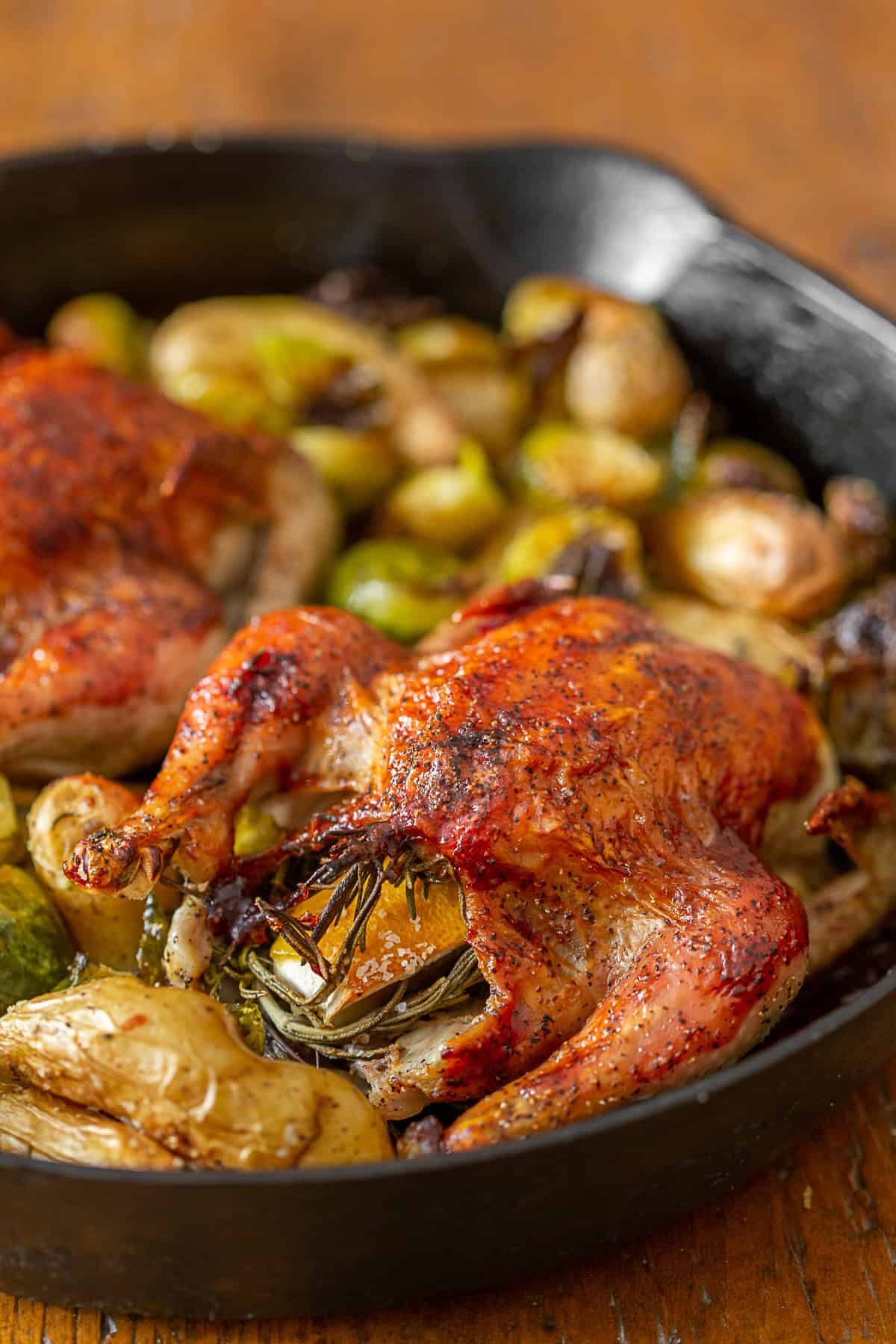 Cranberry BBQ Sauce Cornish Hens in a skillet. 