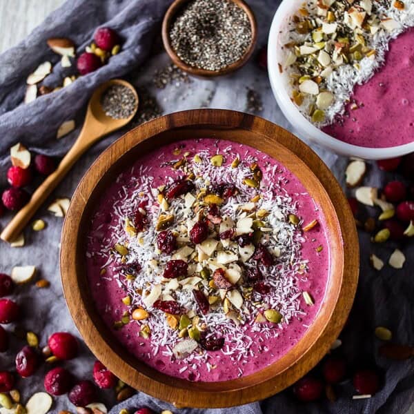 This cranberry smoothie bowl is packed full of cranberries, mixed berries, bananas, almond milk and topped with coconut, chia seeds and nuts. It's healthy, delicious and the perfect holiday rush breakfast.