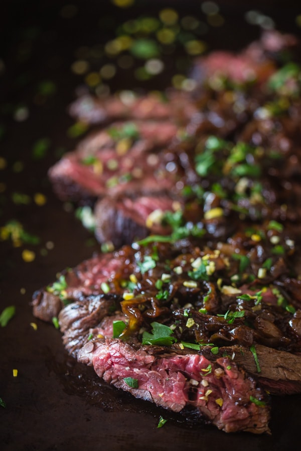 This Newcastle brown ale marinated hanger steak is the perfect holiday meal. Perfectly cooked and topped with Newcastle caramelized onions. You need this!