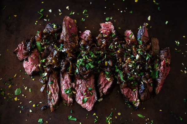 This Newcastle brown ale marinated hanger steak is the perfect holiday meal. Perfectly cooked and topped with Newcastle caramelized onions. You need this!