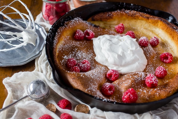 This eggnog Dutch baby is spiced with holiday flavor and topped with a homemade Greek yogurt whipped cream. So deliciously perfect in every single way.
