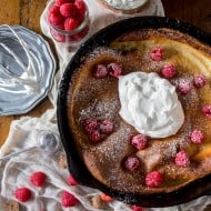 This eggnog Dutch baby is spiced with holiday flavor and topped with a homemade nutmeg whipped cream. So deliciously perfect in every single way.