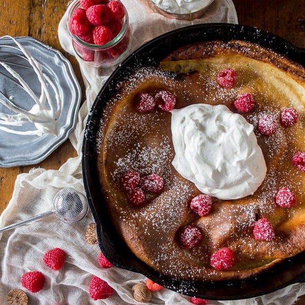 This eggnog Dutch baby is spiced with holiday flavor and topped with a homemade nutmeg whipped cream. So deliciously perfect in every single way.