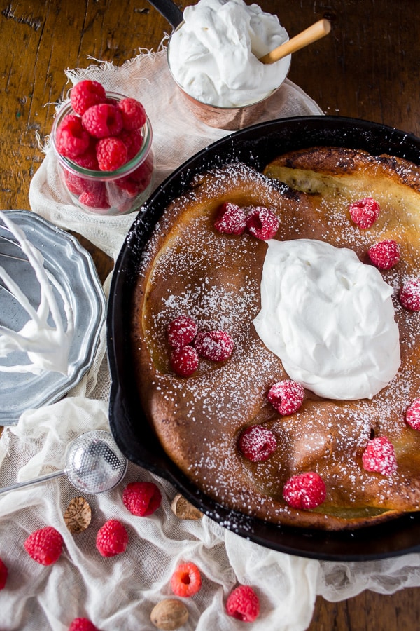 This eggnog Dutch baby is spiced with holiday flavor and topped with a homemade Greek yogurt whipped cream. So deliciously perfect in every single way.