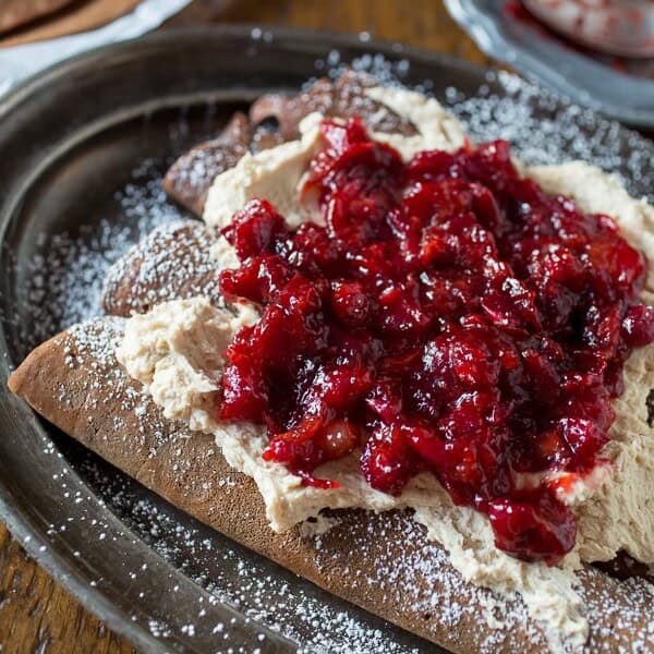 These gingerbread crepes with cranberry ginger compote are the perfect winter dessert. Full of fluffy vanilla mascarpone filling and ready in under an hour!