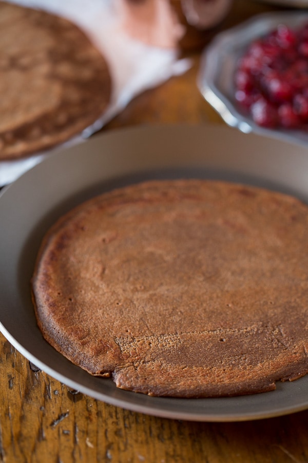These gingerbread crepes with ginger cranberry compote are the perfect winter dessert. Full of fluffy vanilla mascarpone filling and ready in under an hour!