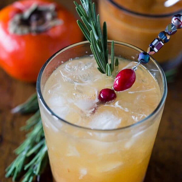 This persimmon old fashioned cocktail is a tasty winter libation. Made with a sweet persimmon puree, rye and just a touch of seltzer. So easy to make and drink!