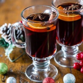 This slow cooker spiced mulled wine is perfect for large holiday gatherings. So warm and comforting it's bound to be the drink of the season. Plus it's kept warm all night long by heating in the slow cooker.