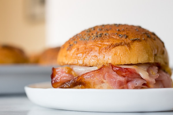 Side view of baked ham and cheese party sandwich.
