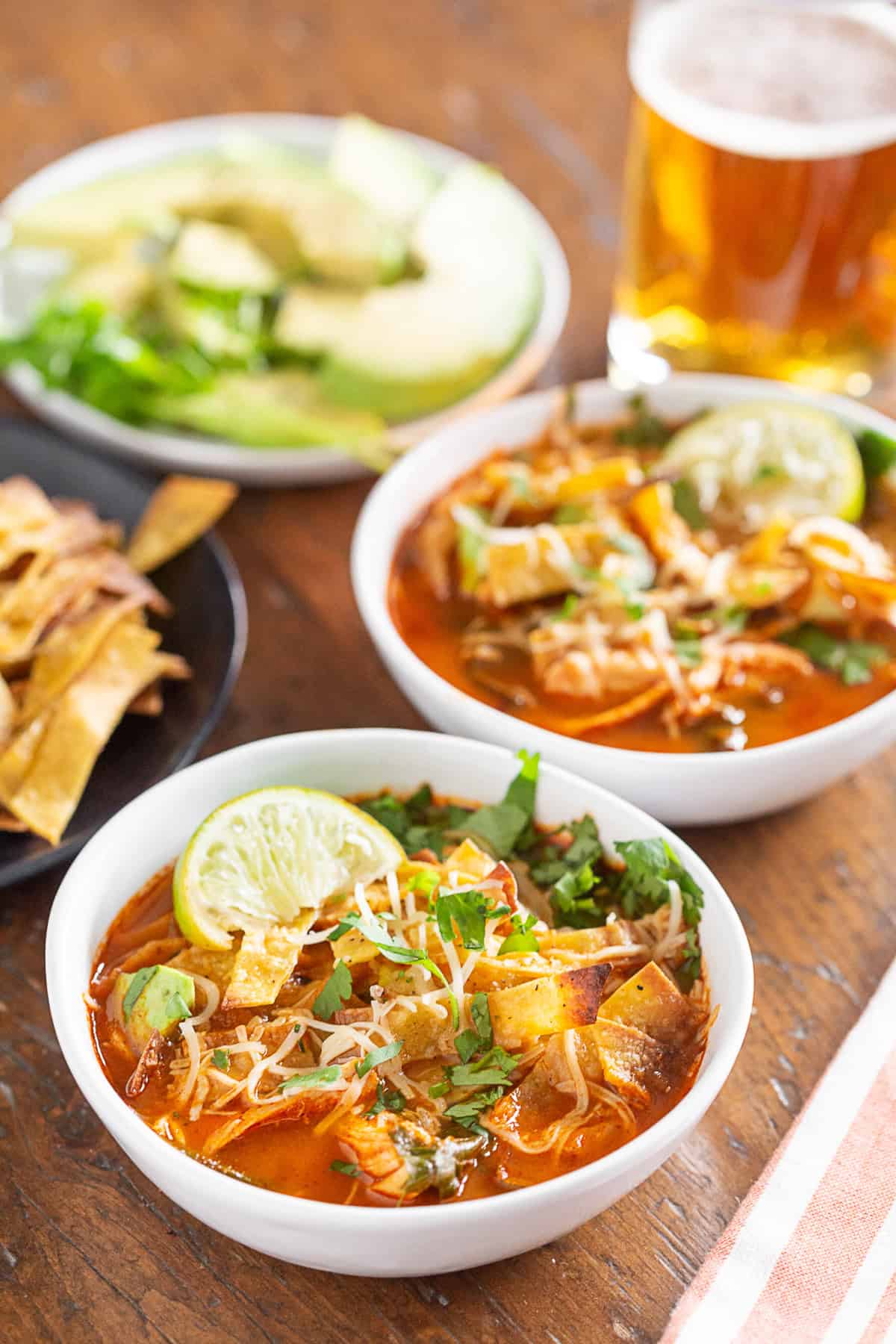chicken and chard tortilla soup topped with tortilla strips and served with a beer