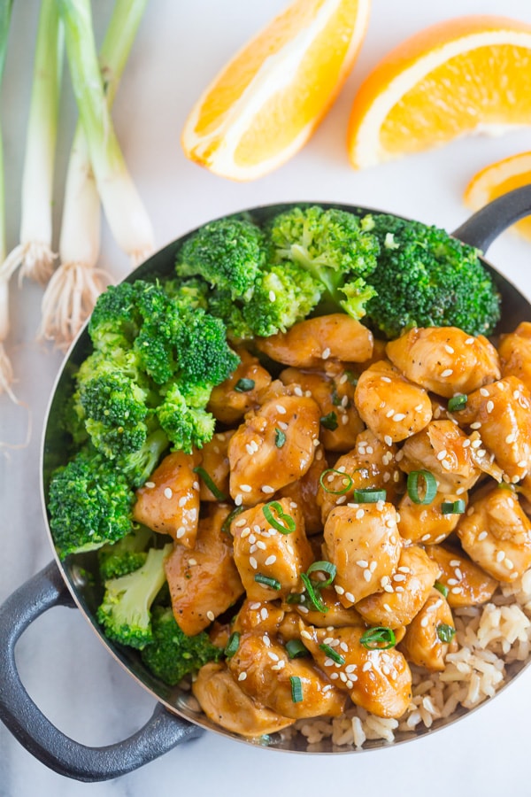 This 20 minute healthier orange chicken is the perfect weeknight dish. Why pay for take out when you can make this quick and easy dish from scratch. Healthier Orange Chicken in a round bowl.
