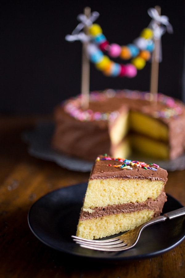 A slice of cake topped with Easy Whipped Chocolate Frosting. 