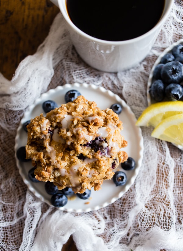 Blueberry Lemon Thyme Muffins on a plate with blueberries. 