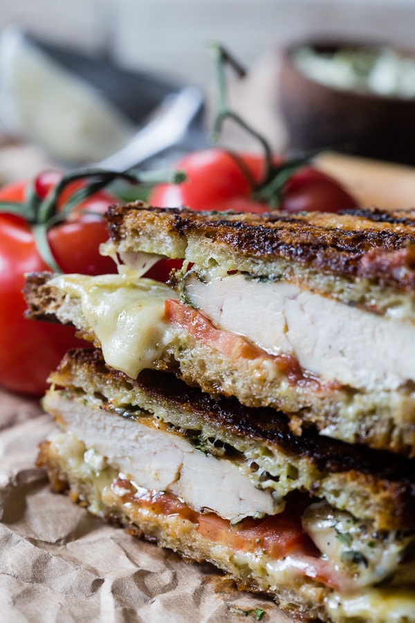 This grilled chicken pesto panini is a quick and easy weeknight meal. Made with grilled marinated chicken, sharp provolone cheese, pesto mayonnaise and ripe tomatoes. You'll love this sandwich so much you'll want to make it every single week!