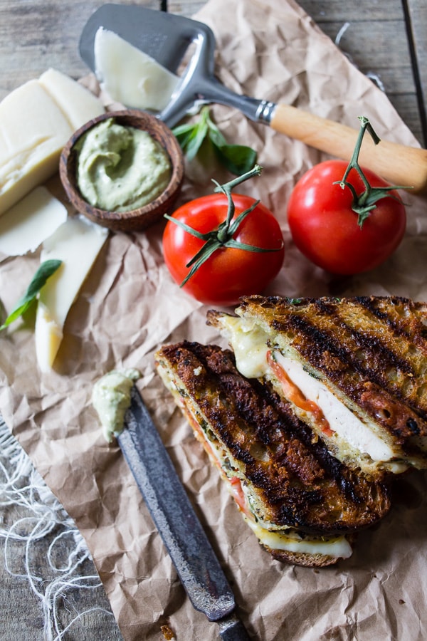 This grilled chicken pesto panini is a quick and easy weeknight meal. Made with grilled marinated chicken, sharp provolone cheese, pesto mayonnaise and ripe tomatoes. You'll love this sandwich so much you'll want to make it every single week!