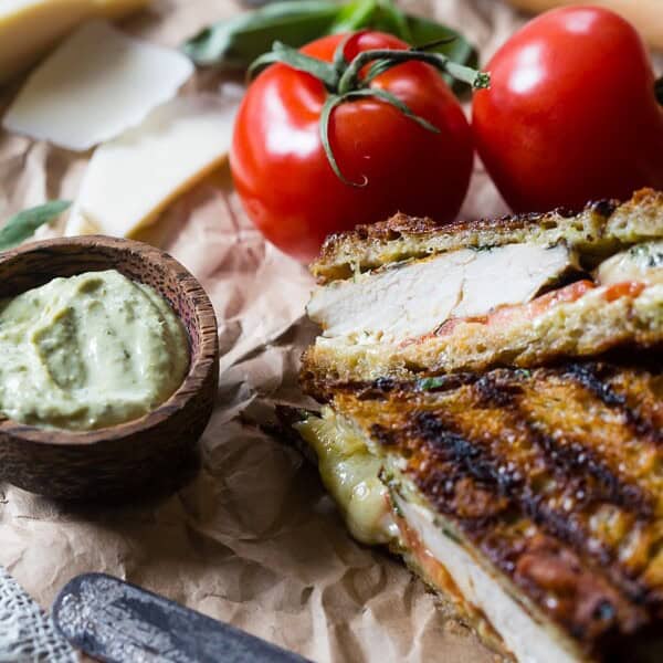 This grilled chicken pesto panini is a quick and easy weeknight meal. Made with grilled marinated chicken, sharp provolone cheese, pesto mayonnaise and ripe tomatoes. You'll love this sandwich so much you'll want to make it every single week!