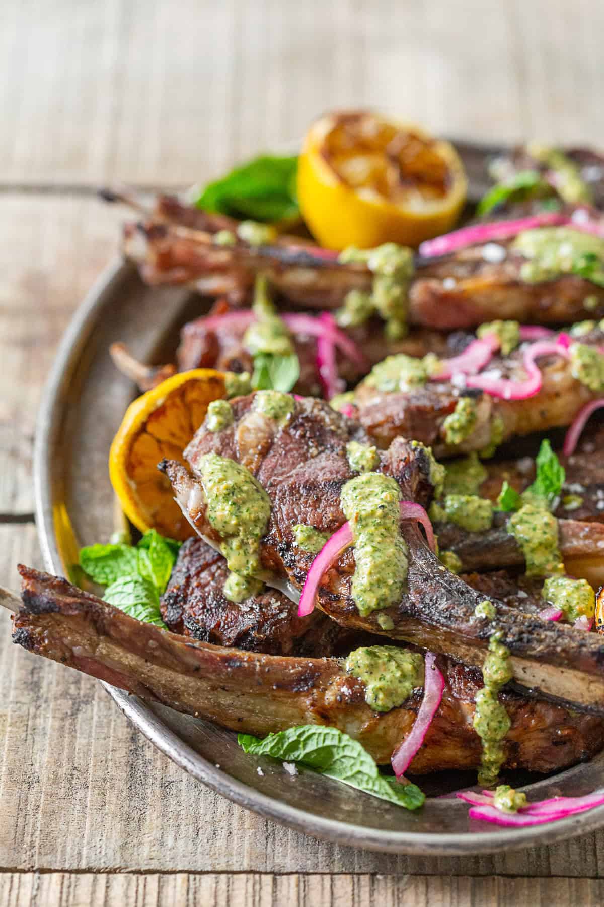 Grilled Lamb Chops with Pistachio Mint Pesto on a platter.