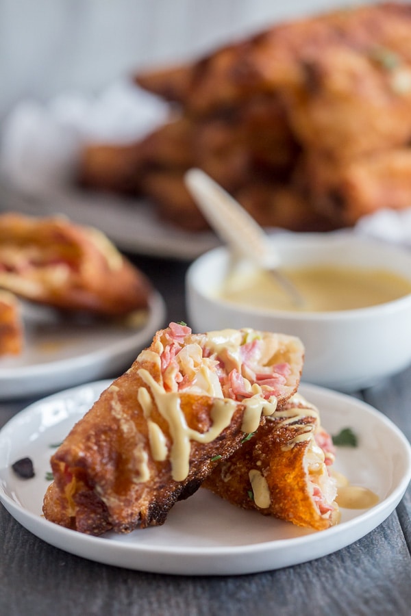 Reuben Egg Rolls cut in half to show corned beef. 