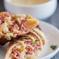 These reuben egg rolls are packed full of corned beef, cabbage, sauerkraut and Russian dressing. Fried till crispy and dipped in an beer mustard sauce. Easy to make and PACKED full of delicious reuben flavor.