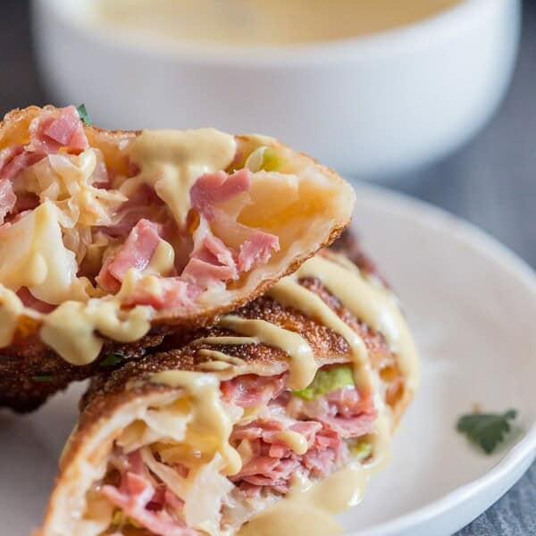 These reuben egg rolls are packed full of corned beef, cabbage, sauerkraut and Russian dressing. Fried till crispy and dipped in an beer mustard sauce. Easy to make and PACKED full of delicious reuben flavor.