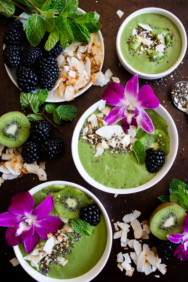 This tropical green smoothie bowl is made with frozen bananas, mango, kiwi, mint, spinach, chia seeds, vanilla soy yogurt and coconut milk. It's ready in just 5 minutes and tastes like a tropical paradise.