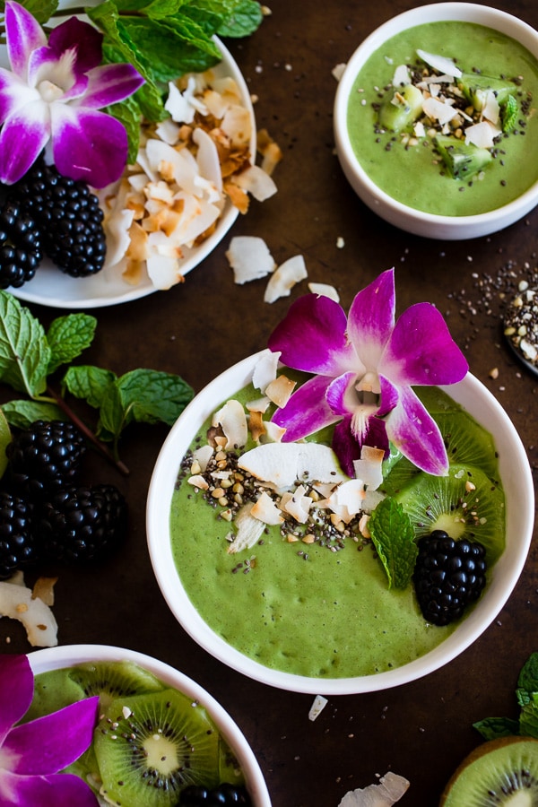 This tropical green smoothie bowl is made with frozen bananas, mango, kiwi, mint, spinach, chia seeds, vanilla soy yogurt and coconut milk. It's ready in just 5 minutes and tastes like a tropical paradise.