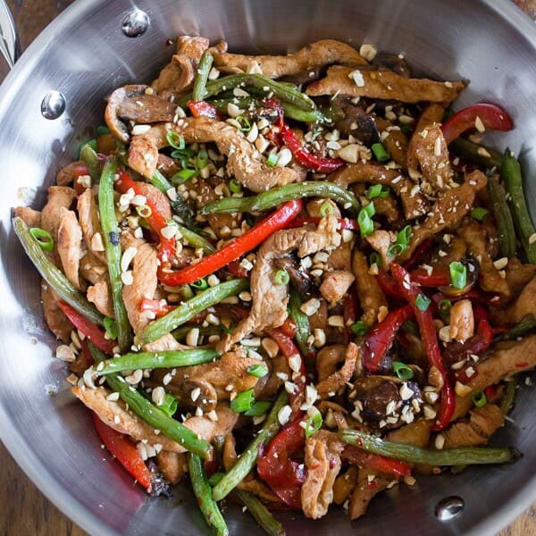 This spicy garlic pork stir fry is the perfect weeknight takeout fakeout! Why order random stir fry when you can make your own super flavorful dish at home? Plus it's ready in just 35 minutes! This stir fry is slightly spicy, full of garlic flavor and packed with marinated pork, mushrooms, red bell pepper and crispy steamed green beans.