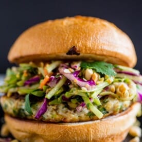 These Thai chicken burgers are packed full of fresh herbs and topped with a crunchy vegetable slaw tossed with a peanut butter dressing. Ready in about 30 minutes and LOADED with flavor!
