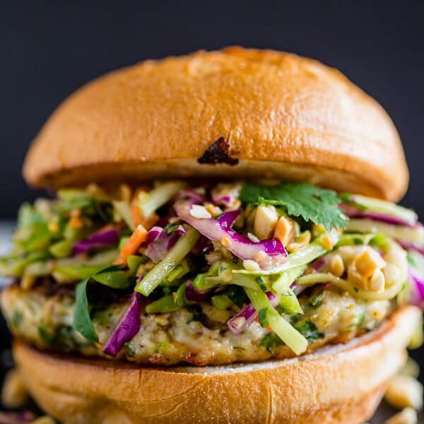 These Thai chicken burgers are packed full of fresh herbs and topped with a crunchy vegetable slaw tossed with a peanut butter dressing. Ready in about 30 minutes and LOADED with flavor!