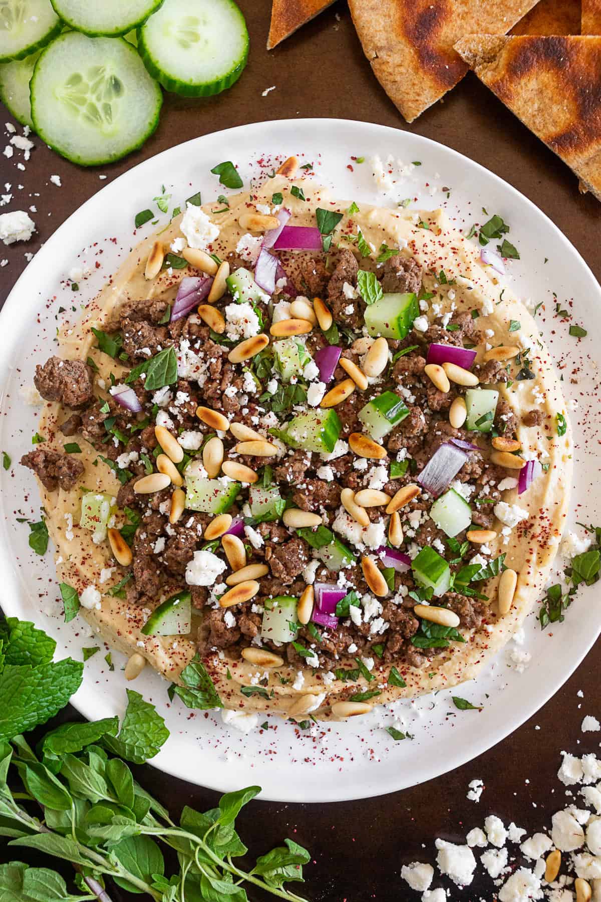 Loaded Greek Hummus on a white plate. 