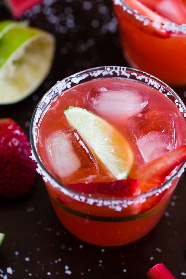This strawberry rhubarb margarita is the perfect way to celebrate spring and Cinco de Mayo. The perfect balance of sweet, tart and tequila! Made with a homemade strawberry rhubarb syrup and served perfectly chilled on the rocks with a salted rim. Cheers to your new summer drink! 