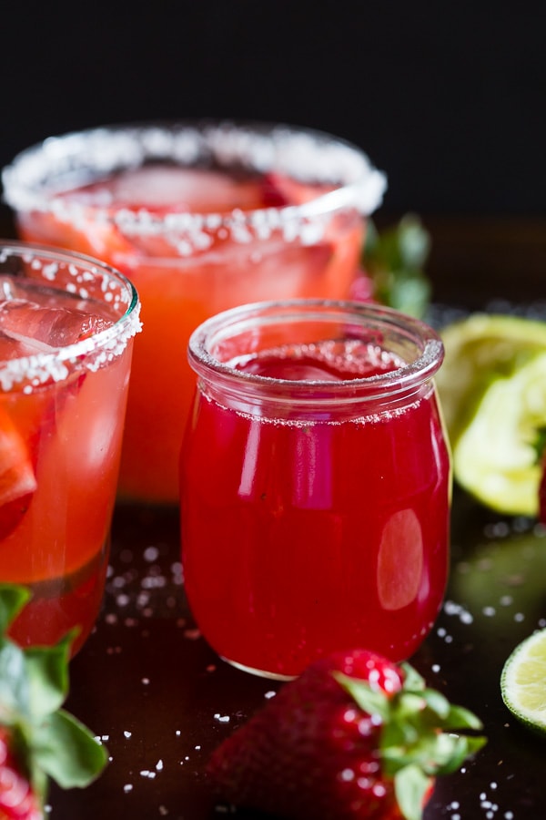 This strawberry rhubarb margarita is the perfect way to celebrate spring and Cinco de Mayo. The perfect balance of sweet, tart and tequila! Made with a homemade strawberry rhubarb syrup and served perfectly chilled on the rocks with a salted rim. Cheers to your new summer drink! 