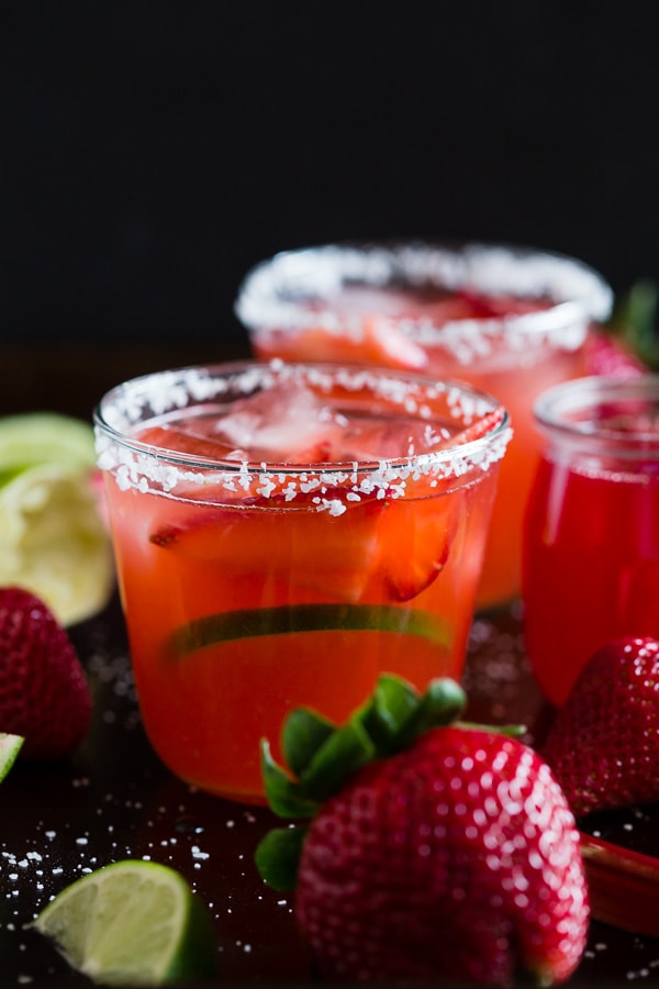 This strawberry rhubarb margarita is the perfect way to celebrate spring and Cinco de Mayo. The perfect balance of sweet, tart and tequila! Made with a homemade strawberry rhubarb syrup and served perfectly chilled on the rocks with a salted rim. Cheers to your new summer drink! 