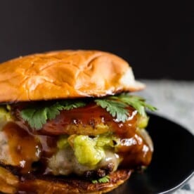 This bbq pineapple burger is the best thing to hit the burger scene. A perfectly seasoned beef patty mixed with cilantro, pineapple bbq sauce and topped with fresh grilled pineapple and smashed avocado!