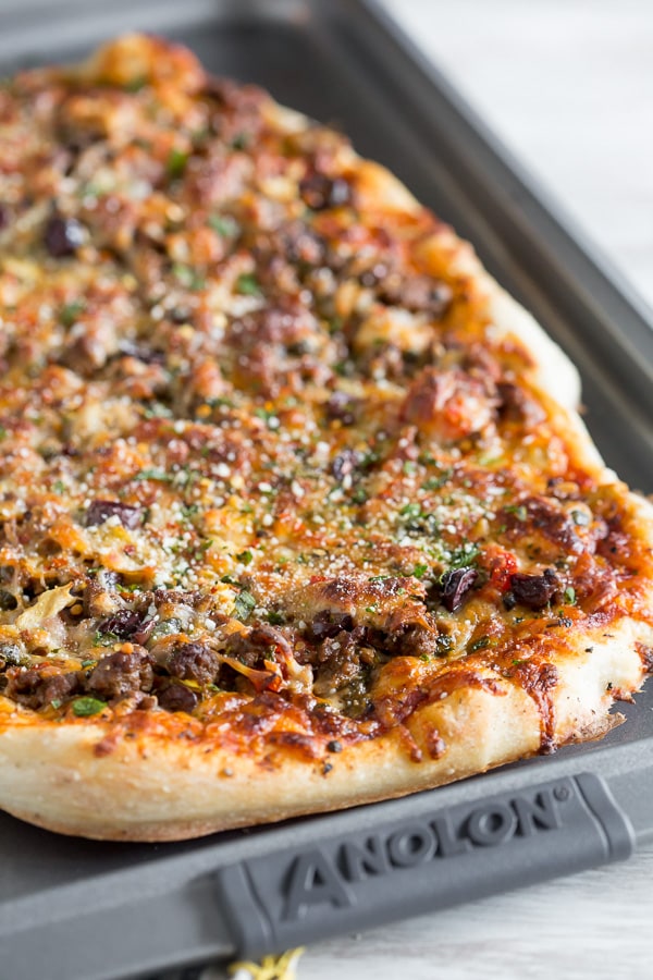 Beef Puttanesca Pizza on a sheet pan. 