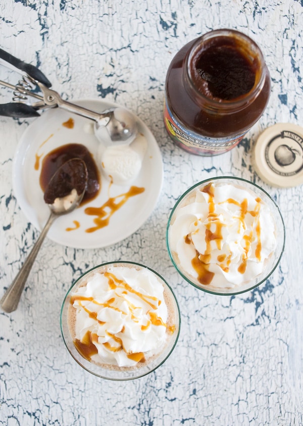 boozy caramel apple butter milkshake topped with whipped cream and a drizzle of caramel