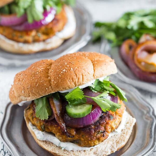 This chicken tandoori burger is packed full of spices and fresh chopped herbs. Piled high with fresh cilantro, cucumber, grilled onions and Greek yogurt sauce. This burger is perfect for all your summer BBQ parties!