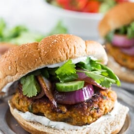 This chicken tandoori burger is packed full of spices and fresh chopped herbs. Piled high with fresh cilantro, cucumber, grilled onions and Greek yogurt sauce. This burger is perfect for all your summer BBQ parties!