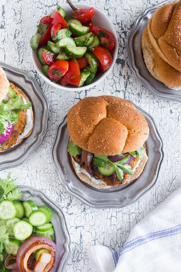 This chicken tandoori burger is packed full of spices and fresh chopped herbs. Piled high with fresh cilantro, cucumber, grilled onions and Greek yogurt sauce. This burger is perfect for all your summer BBQ parties!