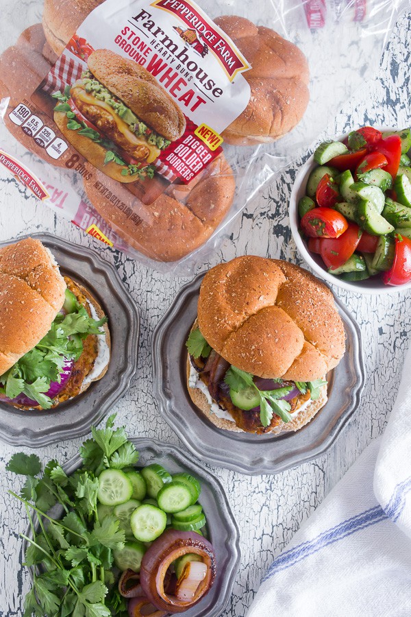 This chicken tandoori burger is packed full of spices and fresh chopped herbs. Piled high with fresh cilantro, cucumber, grilled onions and Greek yogurt sauce. This burger is perfect for all your summer BBQ parties!
