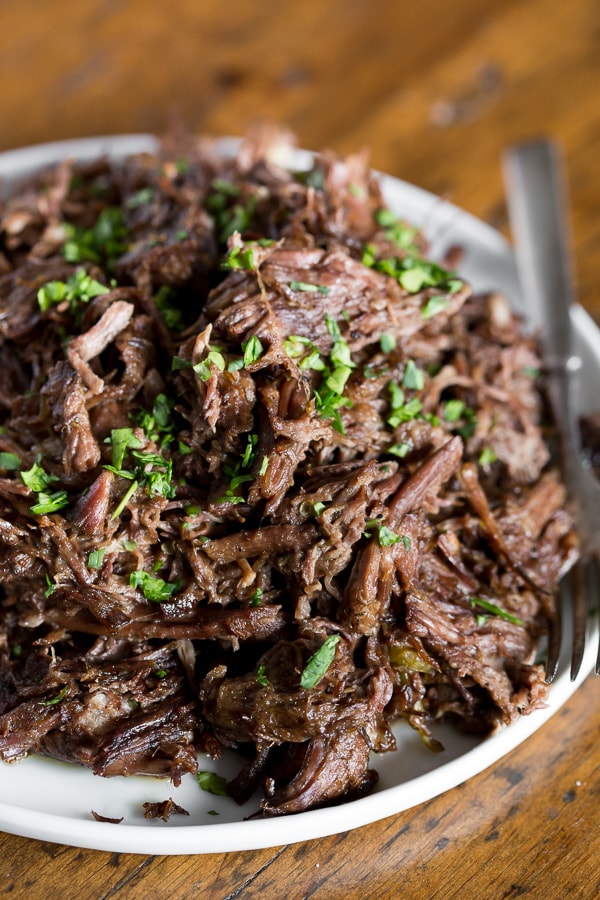 Homemade Mississippi Roast shredded on a plate. 