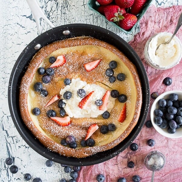 This vanilla bean dutch baby is PACKED full of vanilla beans and topped with lots of fresh summer berries. It's so easy to make and sure to impress your whole family. Plus, who doesn't love vanilla beans and berries?