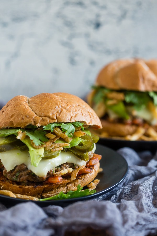 Baja Burger on a table with another burger in the back. 