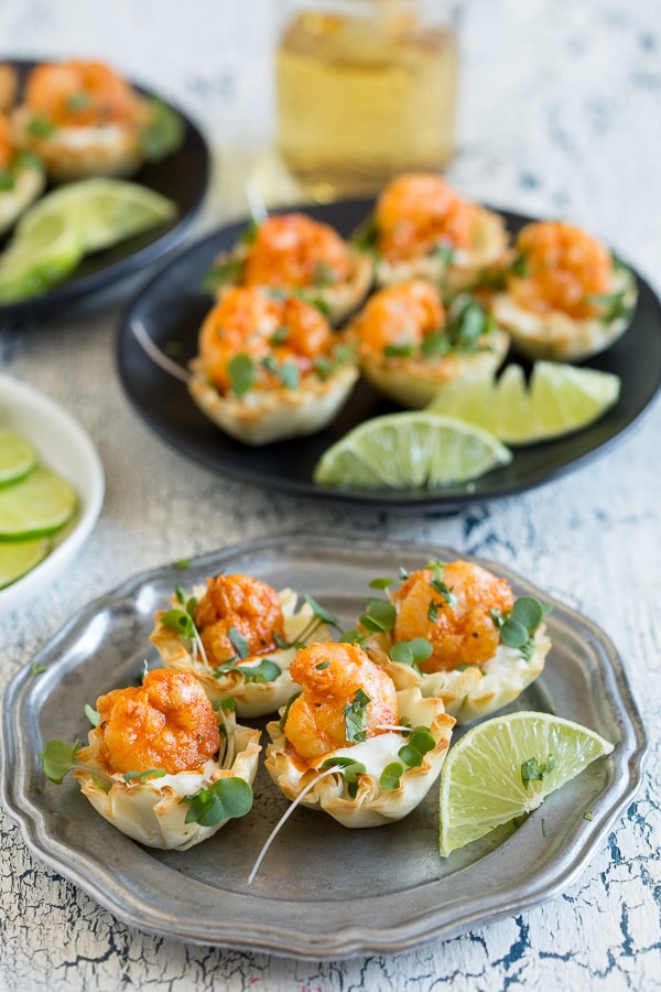 Tequila Lime Shrimp Phyllo Cups on a plate with fresh lime. 